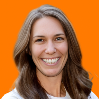 Smiling woman with long, wavy hair against a bright orange background, radiating warmth and approachability