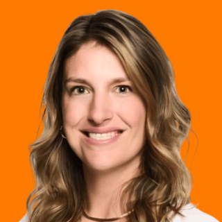 Smiling Sarah McConnell with wavy hair against an orange background, exuding a warm and approachable vibe